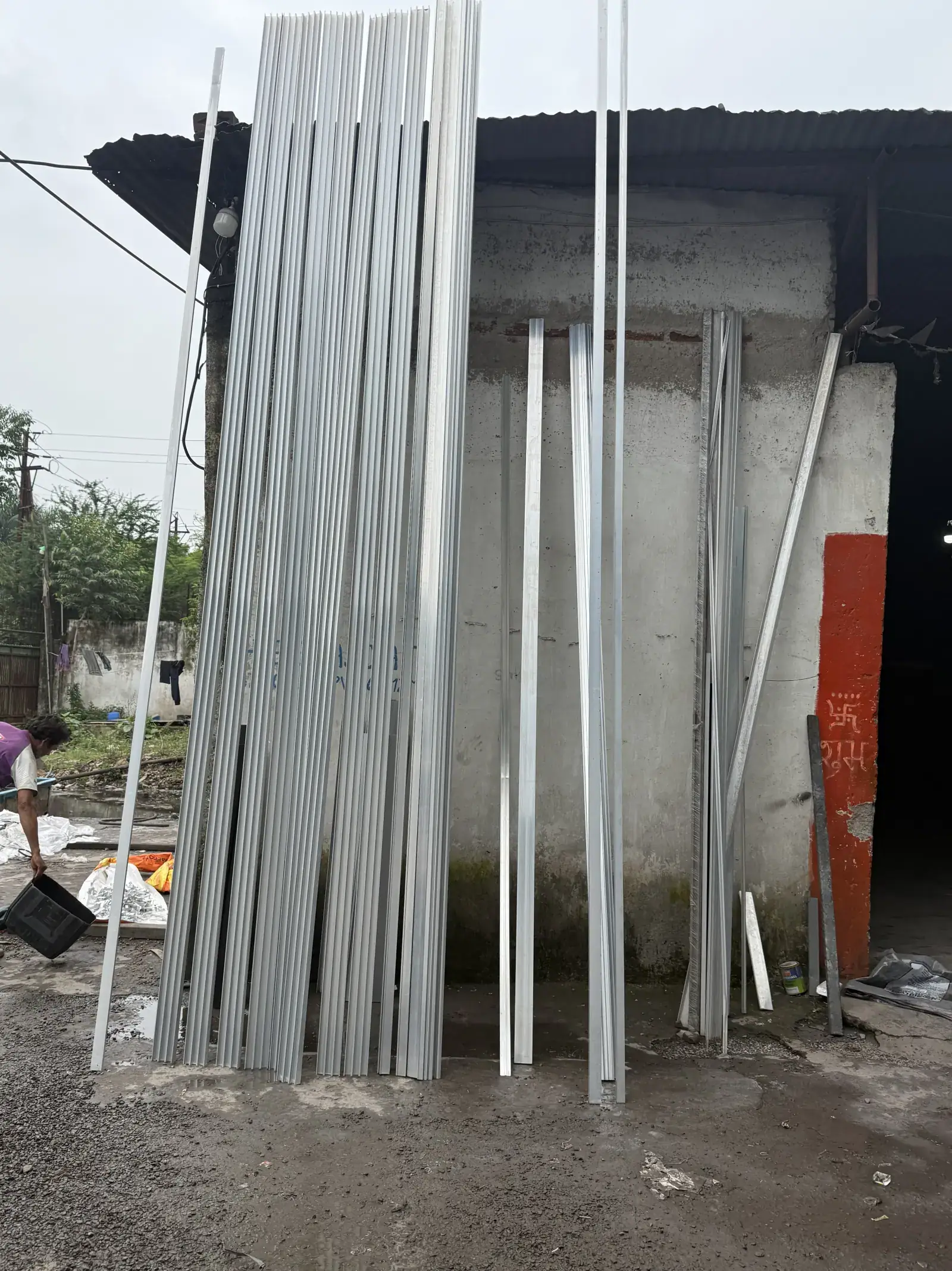Long aluminium extrusion profiles stacked at Shree Balaji Coat powder coating workshop in Raipur